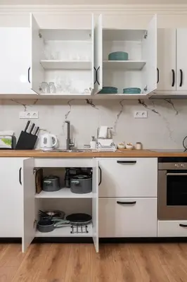 a kitchen with white cabinets and a counter at Бизнес & Арт апартамент - до Панаира и Капана in Plovdiv