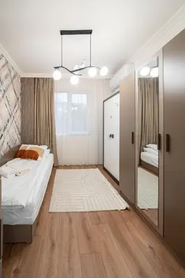 a small bedroom with a bed and a closet at Бизнес & Арт апартамент - до Панаира и Капана in Plovdiv