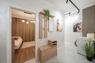 a room with a bedroom with a bed and a hallway at Бизнес & Арт апартамент - до Панаира и Капана in Plovdiv