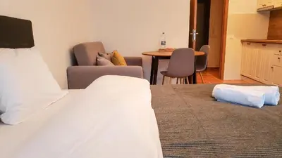 a bedroom with a bed and a table and chairs at Studios in Semiramida Gardens - 8,10,28 in Borovets