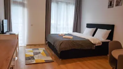 a bedroom with a large bed with a window at Studios in Semiramida Gardens - 8,10,28 in Borovets