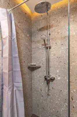 a shower with a glass door in a bathroom at Downtown Modern Studio with Balcony by Flat Mаnager in Plovdiv