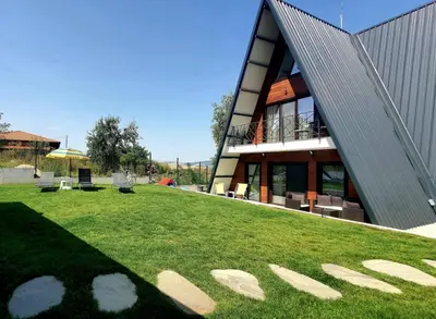 a building with a grass field in front of it at Magnika in Sapareva Banya