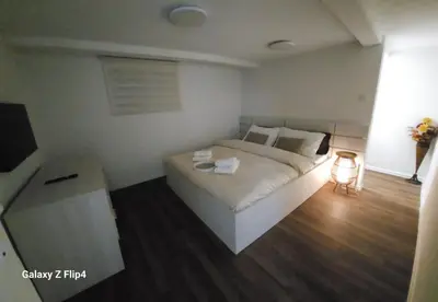 a bedroom with a large white bed in a room at Guest Suite SUZY in Petrich