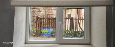 a sliding glass door with a view of a building at Guest Suite SUZY in Petrich