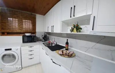 a kitchen with a counter with a sink and a dishwasher at Guest Suite SUZY in Petrich