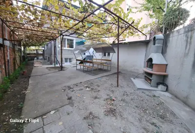 an outdoor patio with a pizza oven and a table at Guest Suite SUZY in Petrich