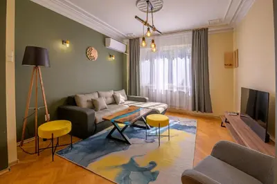 a living room with a couch and a table at 2 DeLuxe Apartments, Top Center Free Parking, 4 BDR in Sofia