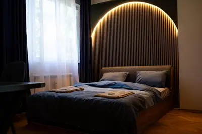 a bedroom with a bed with two towels on it at 2 DeLuxe Apartments, Top Center Free Parking, 4 BDR in Sofia