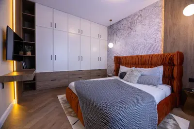 a bedroom with a large bed with white cabinets at Art Retreat Zaimov in Sofia