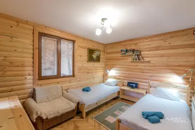 a room with two beds and a chair at Villa Margarita 1 in Semkovo