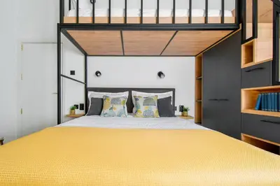 a bedroom with a yellow bed with a loft bed at 2BR, 4 Baths, Terrace Steps from Sofia Landmarks in Sofia