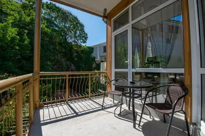 a patio with a table and chairs on a balcony at Apartment Central in Plovdiv