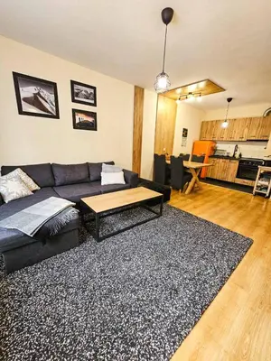 a living room with a couch and a table at Apartment GORA in Borovets