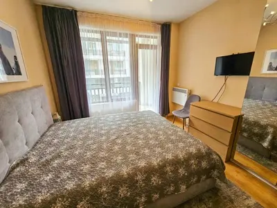 a hotel room with a large bed and a window at Apartment GORA in Borovets