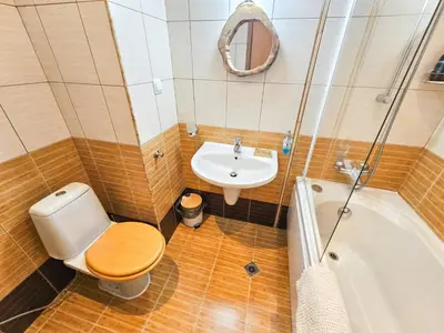 a bathroom with a toilet and a sink at Apartment GORA in Borovets