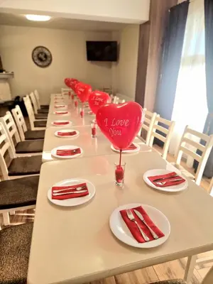 a long table with red napkins and a heart on it at къща за гости Рока in Mineralni Bani
