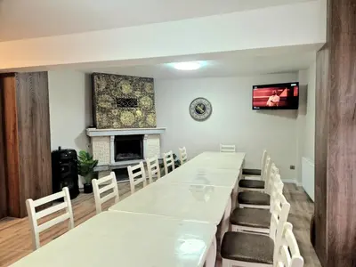 a dining room with a long table and chairs at къща за гости Рока in Mineralni Bani