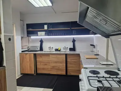a kitchen with a sink and a stove in it at къща за гости Рока in Mineralni Bani