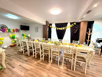a long dining room with a long table and chairs at къща за гости Рока in Mineralni Bani