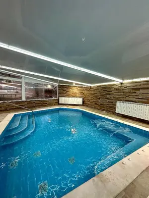 a large swimming pool in a building at къща за гости Рока in Mineralni Bani