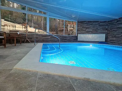 a large swimming pool in a house at къща за гости Рока in Mineralni Bani