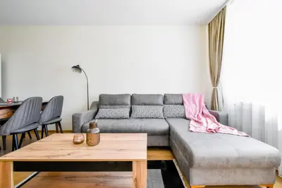 a living room with a couch and a table at Contemporary City Stay by Flat Mаnager in Sofia