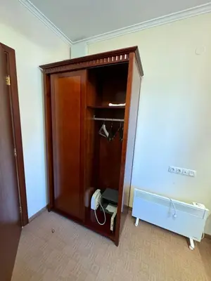 a wooden cabinet with a phone in a room at Gondola Vibes in Bansko