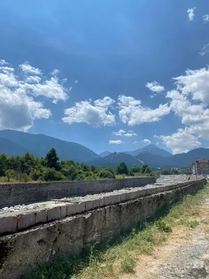 a long retaining wall with mountains in the background at Gondola Vibes in Bansko
