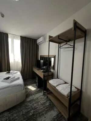 a hotel room with a bunk bed and a desk at Stillaterm SPA in Mineralni Bani