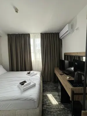 a hotel room with a bed and a desk at Stillaterm SPA in Mineralni Bani