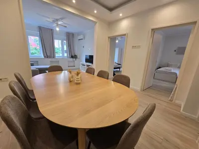 a dining room with a wooden table and chairs at Modern 100m Apt In Sofia Center Vitosha Blvd in Sofia