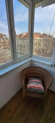 a window seat in a room with two large windows at Bright apartment in Doktorska gradina in Sofia