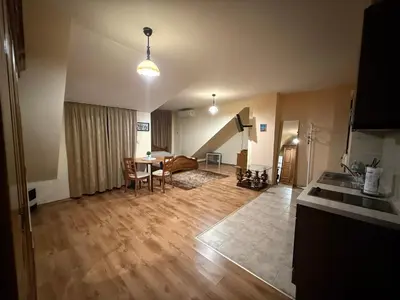 a large living room with a table and a couch at Central Mansard Studio in Sofia
