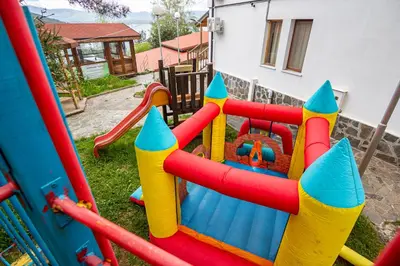 a childrens playground with a colorful play equipment at Комплекс Родопска среща - Къщи и Апартаменти in Batak