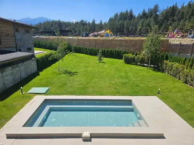 a swimming pool in the middle of a yard at Aquaterra Villa with Hot Pool - Banya in Banya