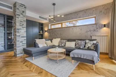 a living room with a couch and a table at Aquaterra Villa with Hot Pool - Banya in Banya