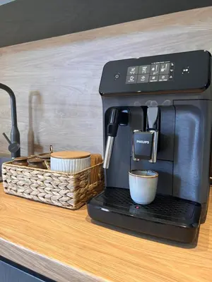 a coffee maker sitting on a counter next to a basket at Aquaterra Villa with Hot Pool - Banya in Banya