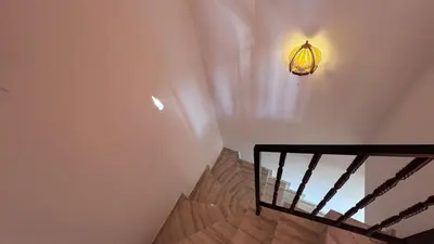 a staircase with a light on the wall and a lamp at Maisonette on the slope in Manastir 3 in Pamporovo