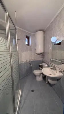a bathroom with a sink and a toilet and a shower at Maisonette on the slope in Manastir 3 in Pamporovo