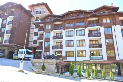 an apartment building with a white van parked in front of it at Charming Studio with Mountain View - Bansko by Flat Mаnаger in Bansko