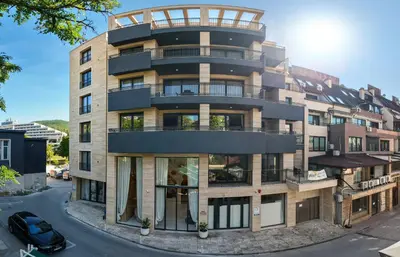 a tall building with a balcony on a street at Nik Palas Luxury Residence in Sandanski
