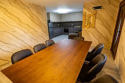 a conference room with a wooden table and chairs at Комплекс Родопска среща - Къщи и Апартаменти in Batak
