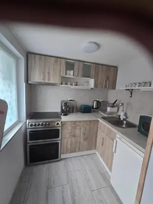 a small kitchen with a stove and a sink at Къща за гости Elion House in Hisarya