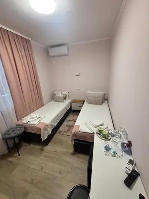 a hospital room with two beds and a table at Къща за гости Elion House in Hisarya