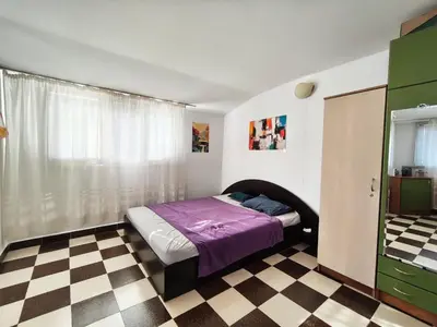 a bedroom with a bed and a checkered floor at AlHana Panoramic Studio - Top Center, Blagoevgrad in Blagoevgrad