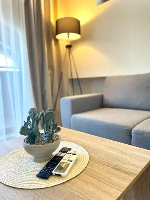 a table with a remote control and a potted plant at Mountain Escape in Green Life Bansko by SI Stay in Bansko
