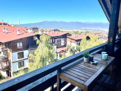 a wooden bench on the balcony of a building at Mountain Escape in Green Life Bansko by SI Stay in Bansko