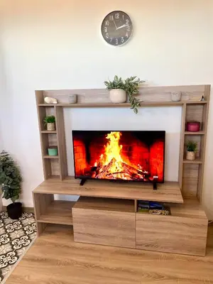 a fireplace in a living room with a fire at Mountain Escape in Green Life Bansko by SI Stay in Bansko