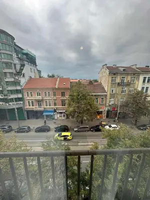 a view of a parking lot with a yellow taxi at Апартамент 36 in Sofia